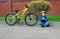 Boy in helmet sitting near his bike. Travelling background. On sport. Transportation summer outdoor activity.