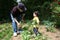 Boy Helping Grandpa In The Garden