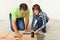 Boy helping his father placing a ceramic floor tile