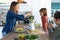 Boy helping his mother to prepare a detox juice with blender in the kitchen at home.