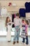 The boy helps girls to choose dress in shop