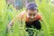 Boy hide in green grass