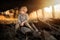 He boy hiker is resting in an old, abandoned shed.