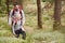 A boy and his father admiring the view while hiking in a forest, front, elevated view