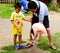 A boy and his father feeding a flamingo