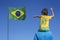 Boy and his father looking up at the Brazilian flag.