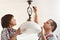 Boy and his father mounting ceiling lamp together
