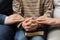 Boy and his godparents praying together, closeup