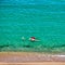 Boy and his mother on beach with inflatable float