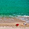 Boy and his mother on beach with inflatable float