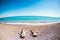 The boy with his mother sunbathe on the beach