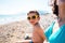 The boy with his mother sunbathe on the beach