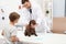 Boy with his pet visiting veterinarian. Doc examining puppy