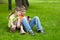 Boy and his sister sit and play electronic game