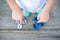 Boy holding blue and rainbow fidget spinners in his hands, view