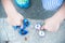 Boy holding blue and rainbow fidget spinners in his hands, view from above both gadgets spinning