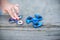 Boy holding blue and rainbow fidget spinners in his hands, view from above both gadgets spinning