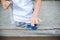 Boy holding blue and rainbow fidget spinners in his hands, view from above both gadgets spinning