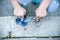 Boy holding blue and rainbow fidget spinners in his hands, view from above both gadgets spinning