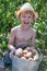 Boy holding bucket of potatoes