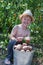 Boy holding bucket of potatoes