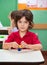 Boy Holding Clay Model At Desk