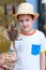 Boy holding gecko on stick