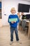 Boy holding green sign with word knowledgeable