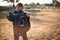 Boy holding horse saddle