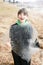 Boy Holding A Large Sheet of Ice from Lake