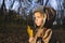 Boy Holding Maple Leaf In Park