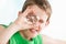 Boy holding a multi faceted crystal against eye