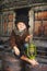 The boy is holding an old kerosene lamp in his hands. Stylized retro portrait