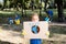 Boy holding placard with globe and