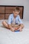 The boy is holding a Pop It toy in his hands. Flexible tactile toy with antistress push bubble