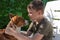 A boy is holding a purebred dog in his arms. Welsh corgi Pembroke. Positive emotions