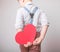 Boy holding a red heart behind the back, symbol of love, family, hope. Backgrounds for cards on Valentine`s Day or social posters