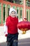 Boy holding red lantern in Courtyard