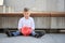 A boy holding a red moneybox.