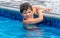 Boy holding safely to the edge of a pool