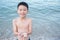 Boy holding shell on the beach
