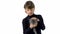 Boy is holding and stroking grey chinchilla at white background. Slow motion.