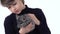 Boy is holding and stroking grey chinchilla at white background. Slow motion. Close up