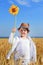 Boy holding a sunflower in the middle of a field