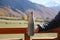 Boy holding thermo bottle with drink in mountains on sunny day, closeup