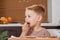 Boy holding a tray full of homemade gingerbread cookies. Kids bake Christmas cookies. Horizontal view of naughty little