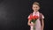 Boy holding tulips standing near chalkboard, congratulating teacher, first love