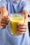 Boy holds a glass with golden turmeric milk