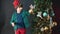 The boy holds in his hands Christmas toys near the New Year tree.