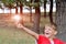 The boy holds an incandescent light bulb, which burns in his hand and looks at her with surprise and admiration